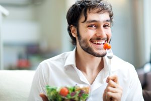 man enjoying a salad