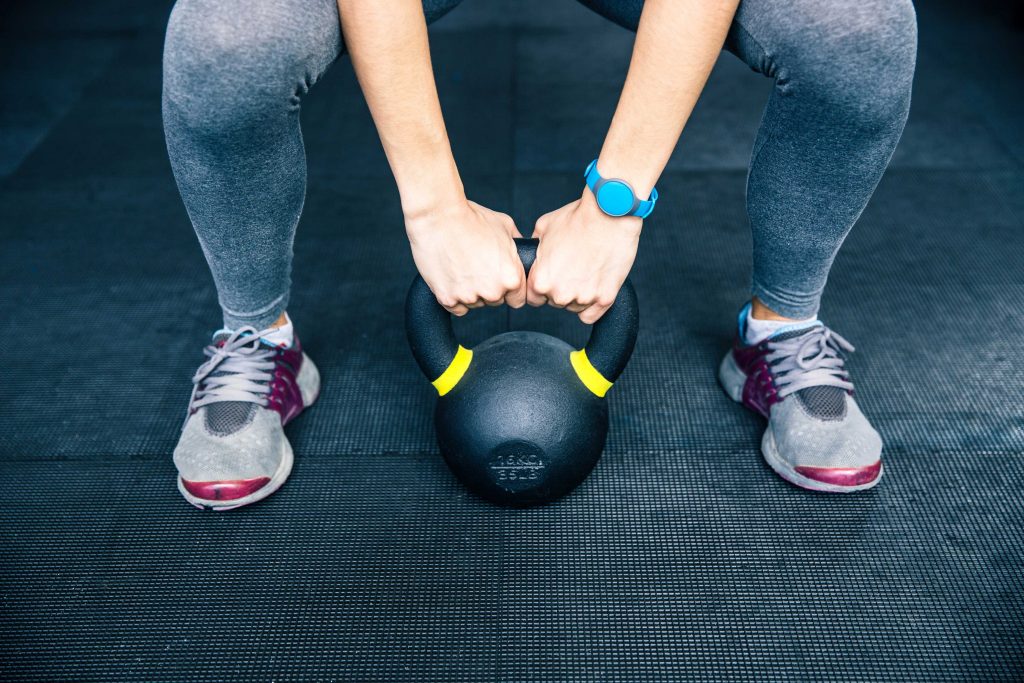 fit female kettle bell exercise